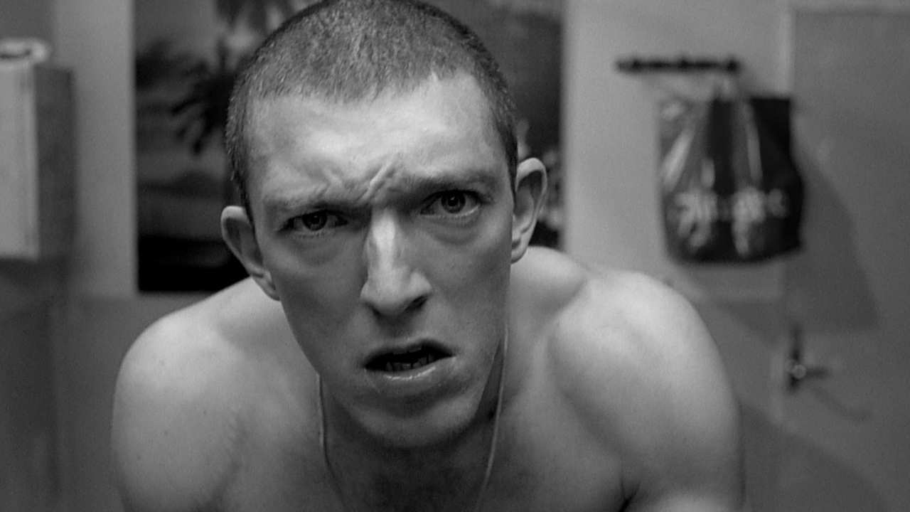 shirtless young man with a shaved head